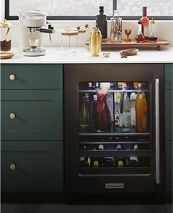 Juniper cabinets surrounding a KitchenAid® undercounter refrigerator.